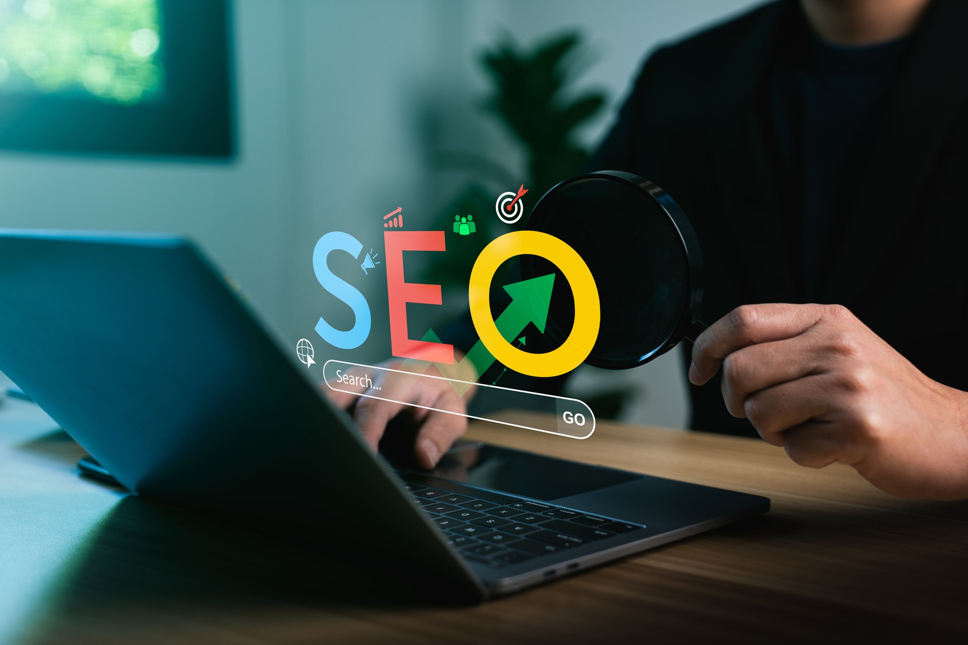 Digital marketing strategy concept showing SEO text with magnifying glass and laptop, illustrating search engine optimization, web traffic analytics, keyword ranking, and online visibility improvement